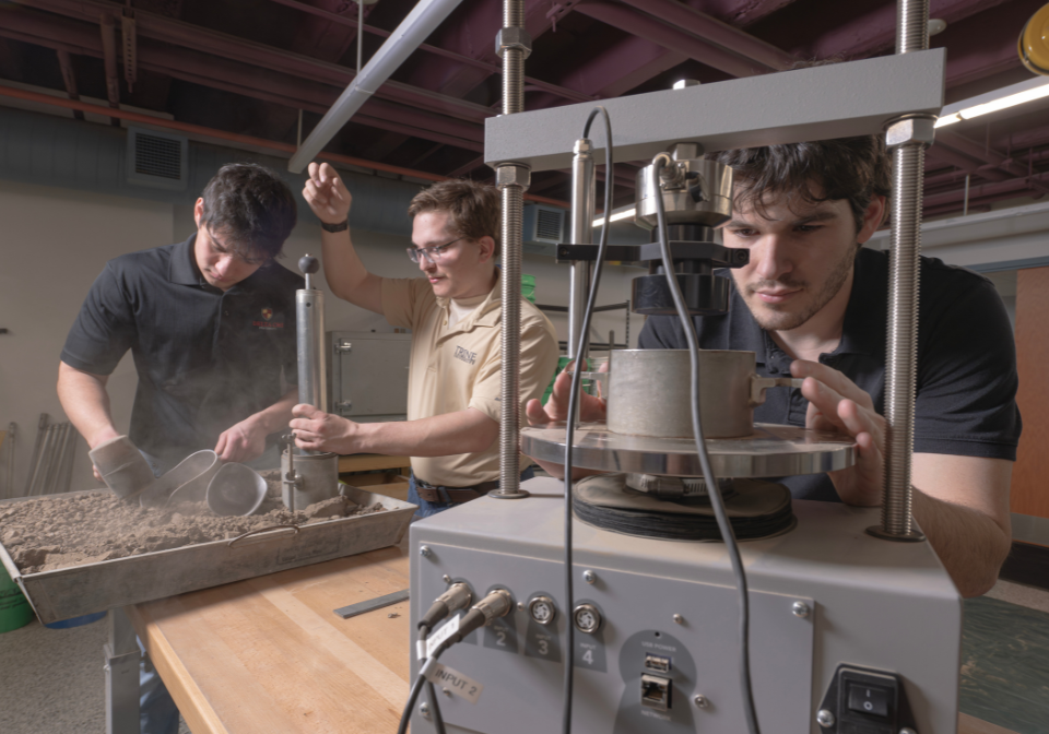 three students test a pumping station