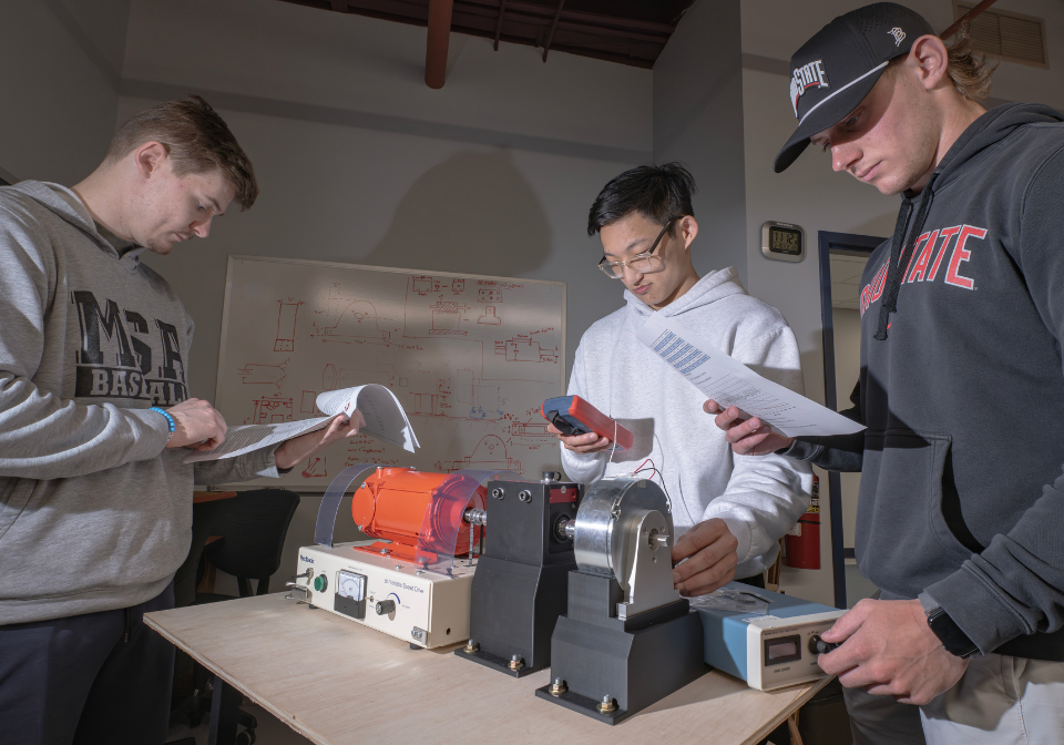 three students studying machine results