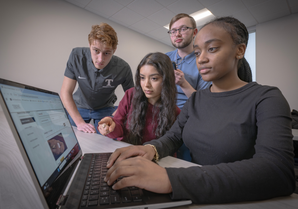 four students view trine patent website