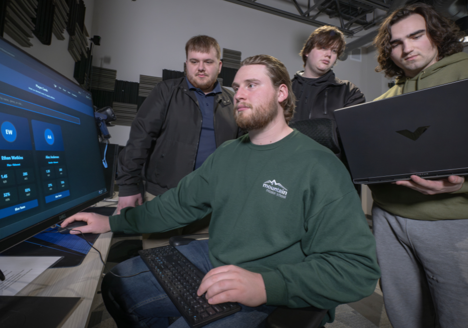 four students view esports tracking website
