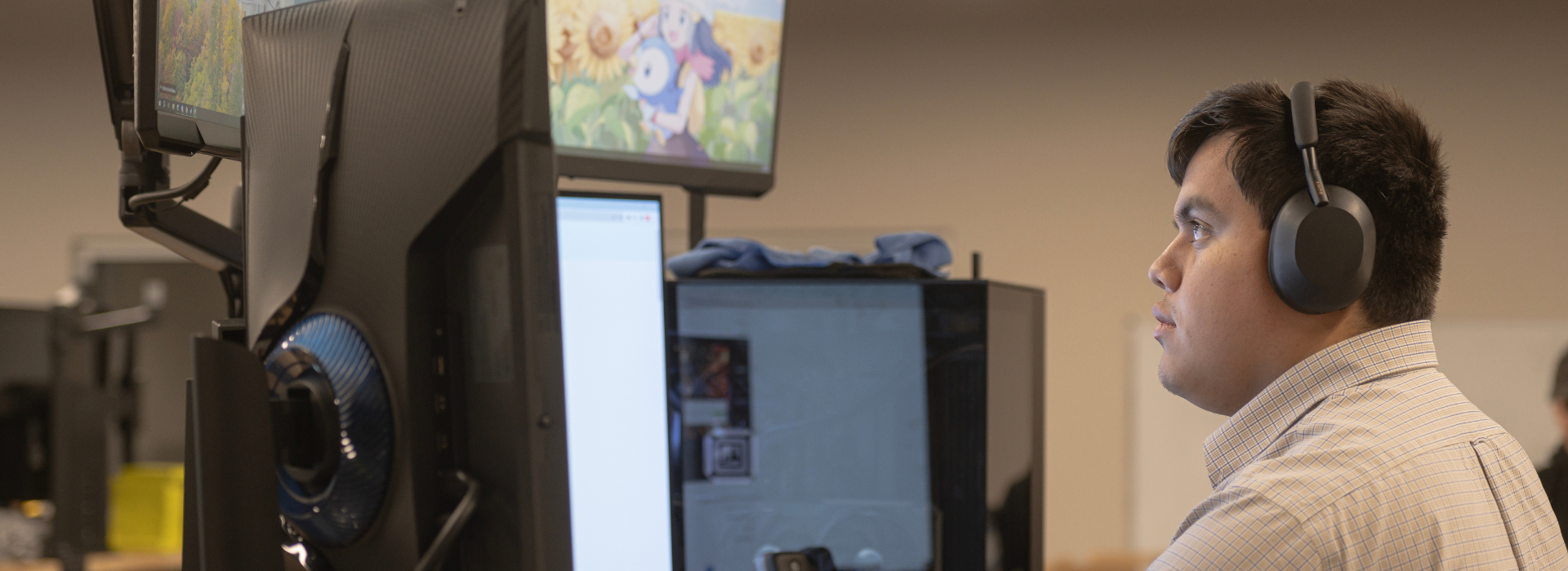 computer science information technology student looking at multiple computer screens