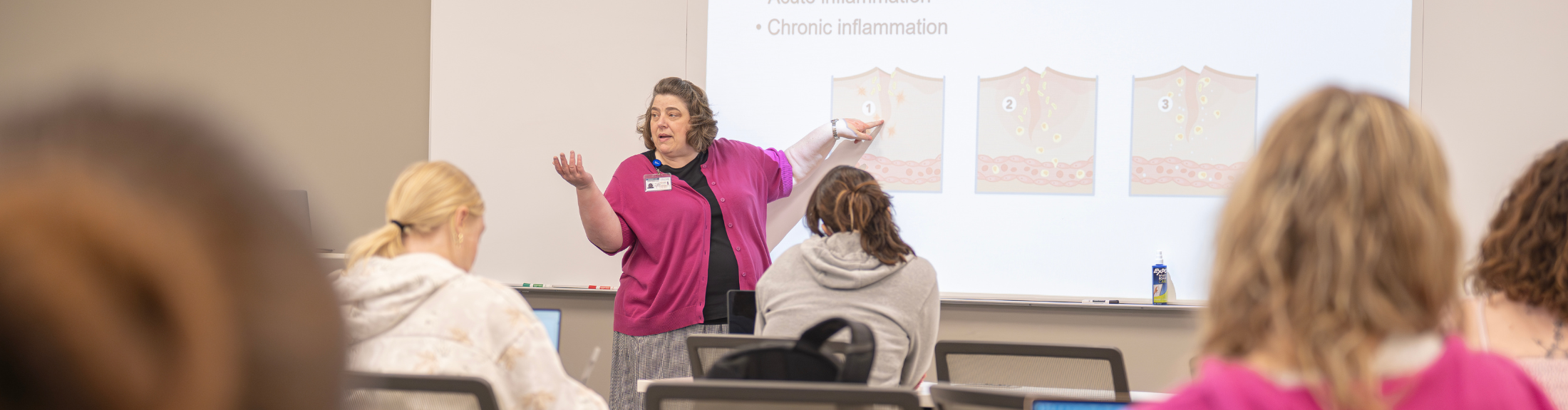 one nursing teacher instructs students in a classroom