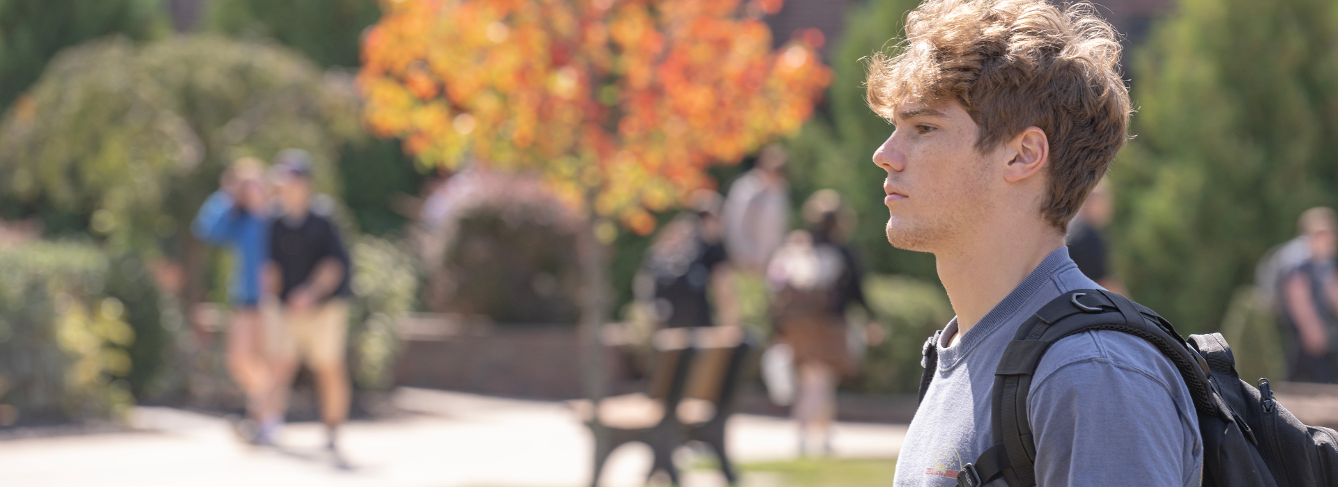 student walking outside on the trine university campus