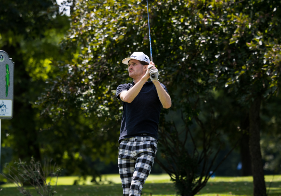 man watch where his golf ball lands after swinging