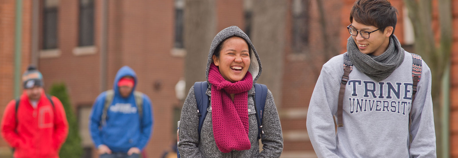 students laughing in front of the fountain