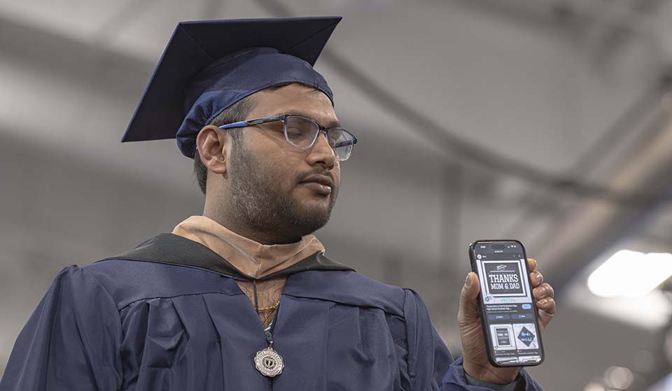 Graduate showing phone message