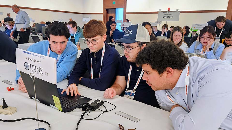 Trine University students at competition table