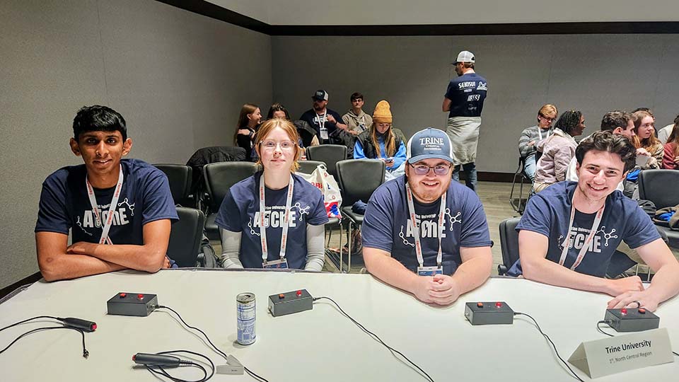 Trine University students at competition table