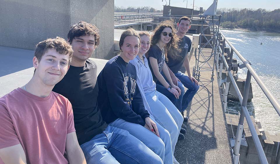 Trine University civil engineering students sitting on dam