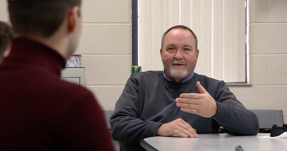 Tom Selman speaks with students
