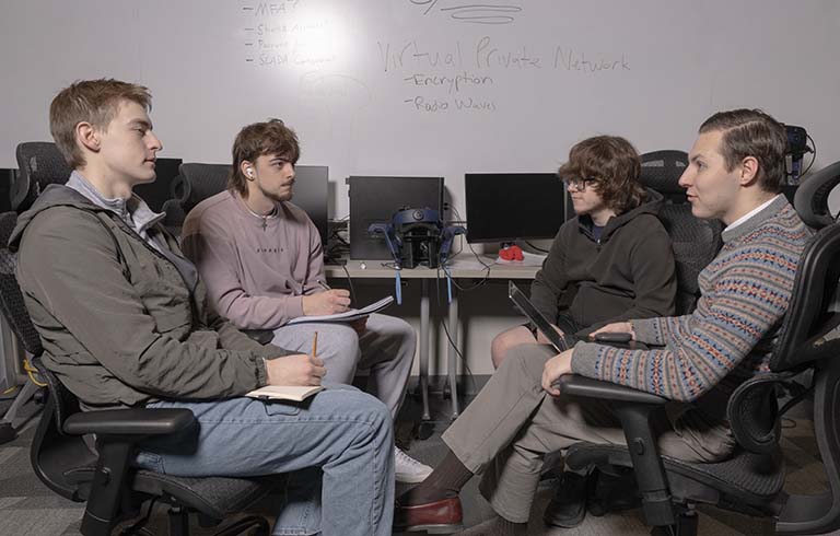 Computer science and information technology majors discussing water treatment safety