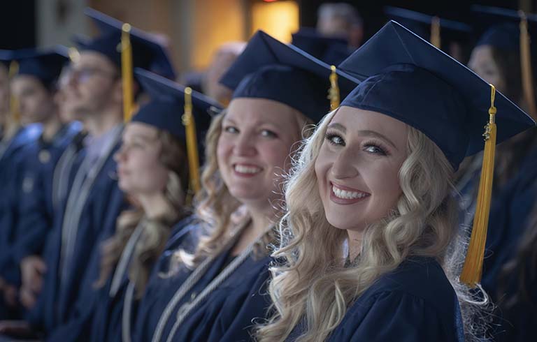 Smiling Trine University graduates