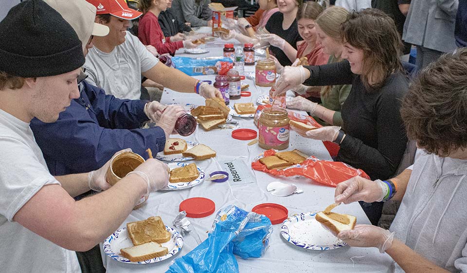 Students making PBJ sandwiches