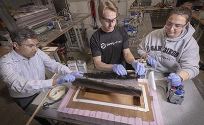 From left, Gurudutt Chandrashekar, Ph.D., associate professor in Trine University's Wade Department of Mechanical and Aerospace Engineering, is guiding research into advanced composites by mechanical engineering majors Joshua Danielowski and Eryn Pikus