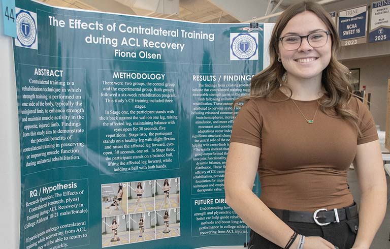 Trine University student with research poster at STEM Symposium