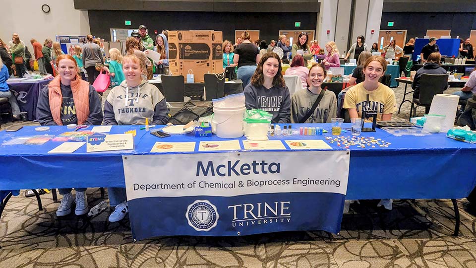 SWE and chemical engineering students at table