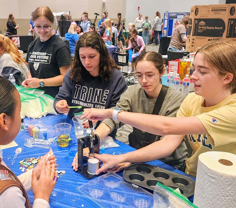 Trine students with Girl Scout at STEM Expo