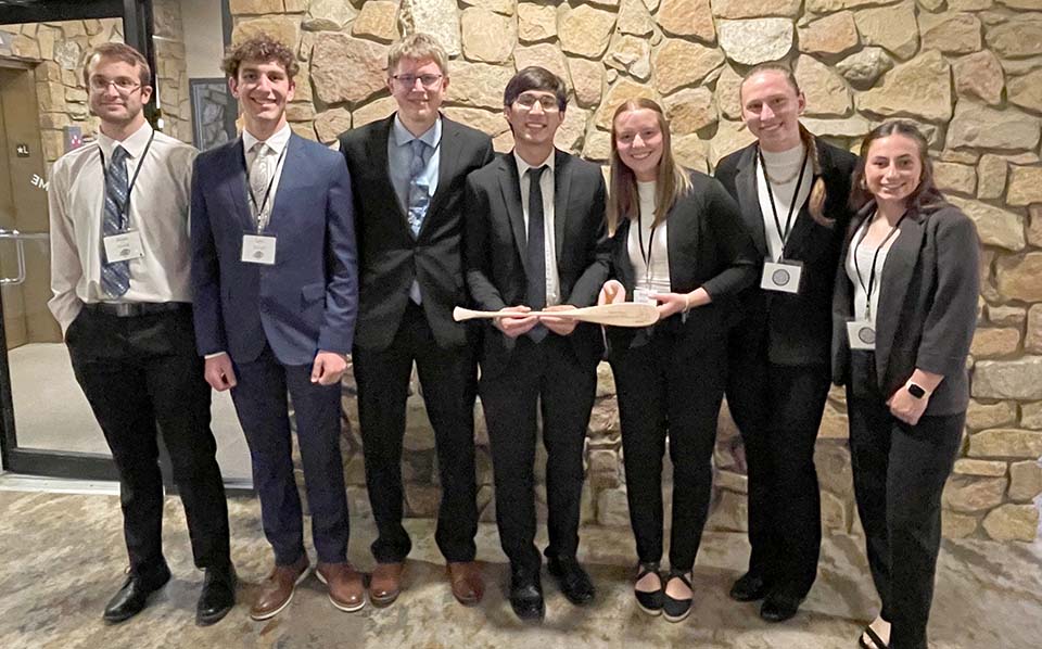 Students with paddle award