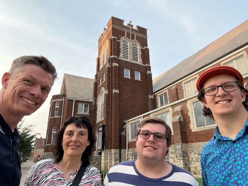 Group of four people in front of building