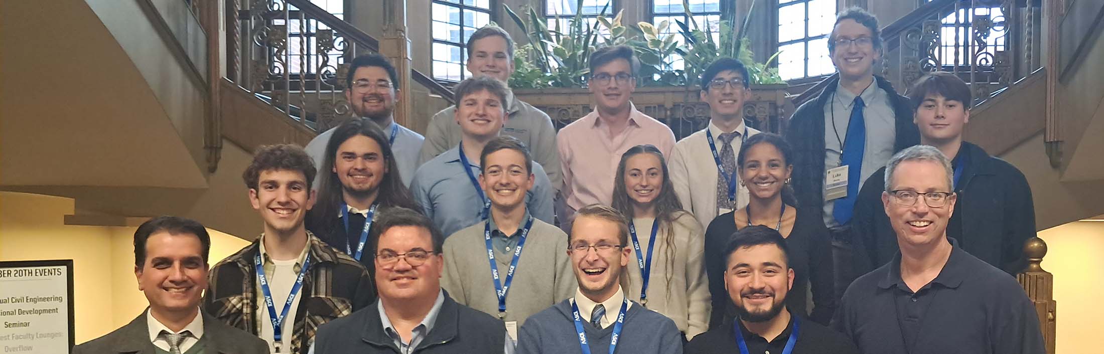 Students and faculty standing on staircase