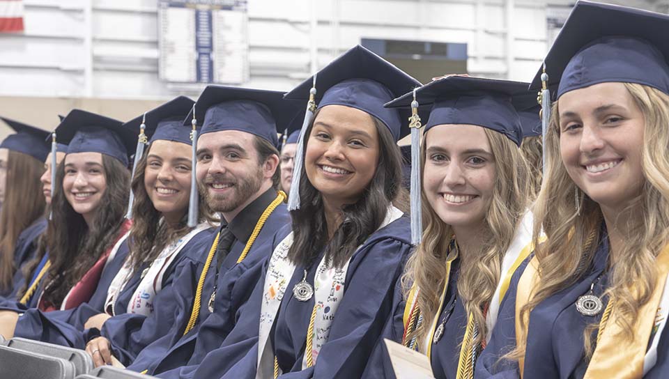 Smiling students in caps and gowns