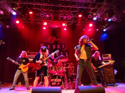 AC/DC tribute band Dirty Deeds on stage at House of Blues with lights and fog.