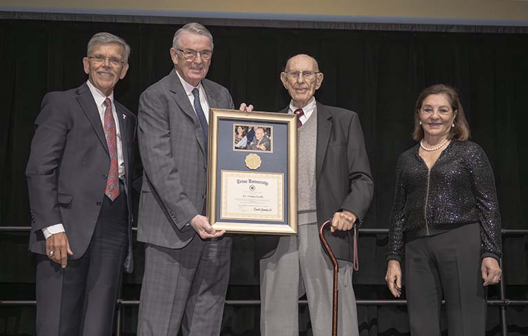 Dr. Brooks, Dr. James holding framed certificate, Dr. Furth and Ema Furth