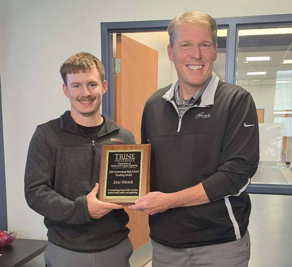 Student handing award to teacher 