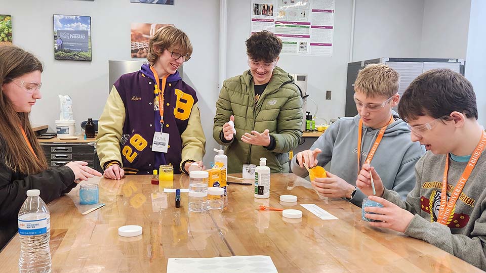 High school students working with lab equipment