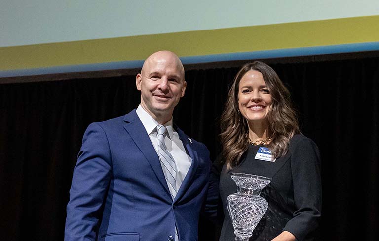 Dr. Kline and Angie Logan. Angie is holding a crystal award.