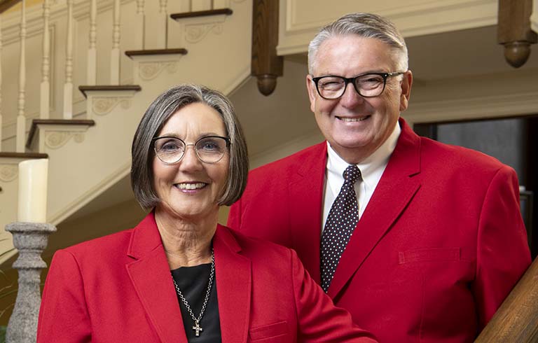Drs. Rick and Vicki James in front of staircase