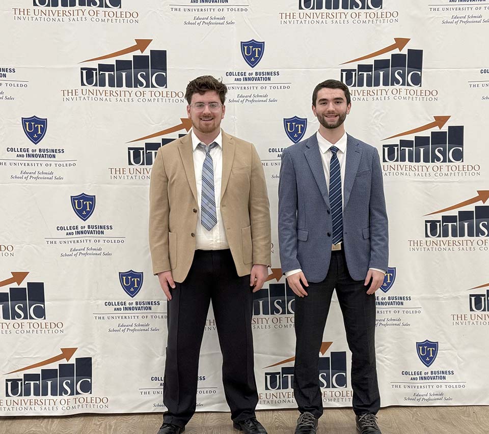 Jacob Seier and Carson Sickmiller in front of UTISC background