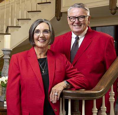 Vicki and Rick James in front of staircase