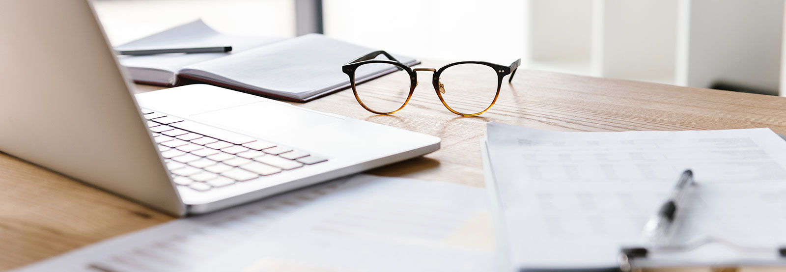 Desk with computer and glasses